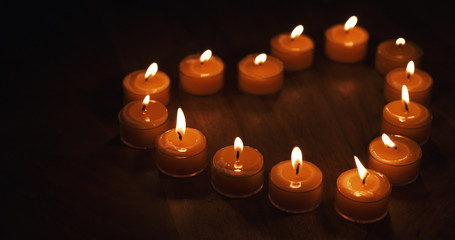 tealight candles in a shape of a heart 4k photo