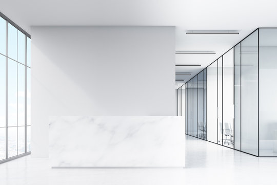 Office hall with panoramic windows and glass walls of meeting rooms. There is a marble reception counter in the left part. 3d rendering. Mock up