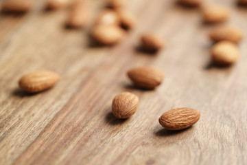 peeled almonds spread on old wooden table, healthy food