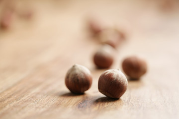 organic hazelnuts on old wooden table closeup photo, shallow focus