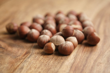 organic hazelnuts on old wooden table closeup photo, shallow focus
