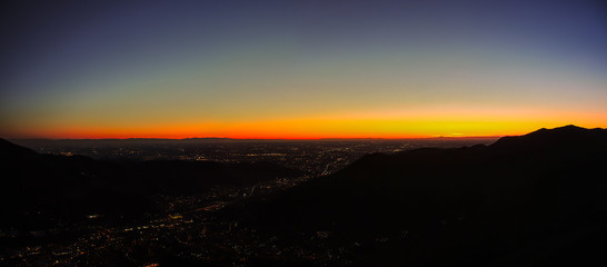 Fiery sunset from mountain pick with thin glazes in the sky evening. Fall season. Orobie alps. The summit of Mount Rena. Bergamo Italy.