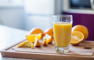 Orange juice on the white table. Shallow depth of field.