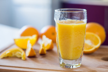 Orange juice on the white table. Shallow depth of field.