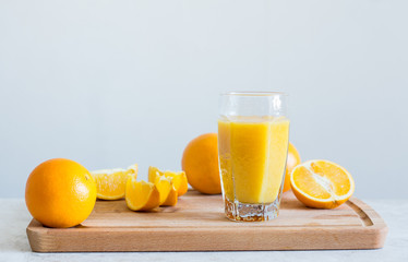 Orange juice on the white table. Shallow depth of field.
