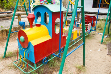 Fototapeta na wymiar Colorful children train in playground.Toys for children