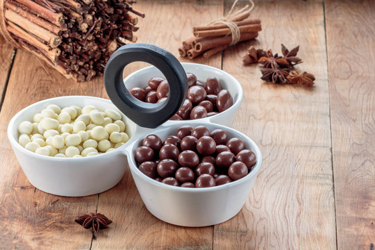 Chocolate dragee in porcelain bowl