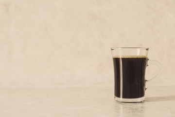 Cup of coffee on the white background. Shallow depth of field. Toned image.
