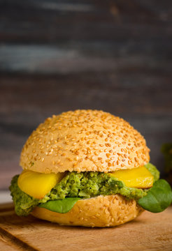 Vegan homemade burger on the rustic wooden background. Shallow depth of field.
