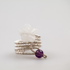 Silver rimgs with colorful precious stones and light grey background