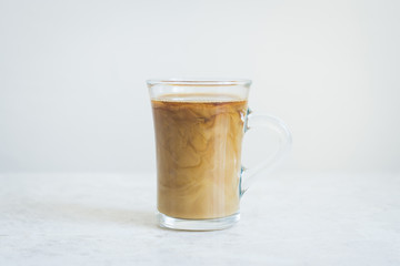 Cup of coffee on the white background. Shallow depth of field.
