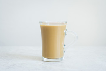 Cup of coffee on the white background. Shallow depth of field.