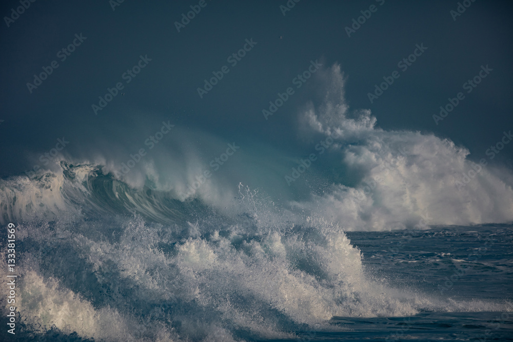 Wall mural huge waves crashing in ocean. seascape environment background. water texture with foam and splashes.