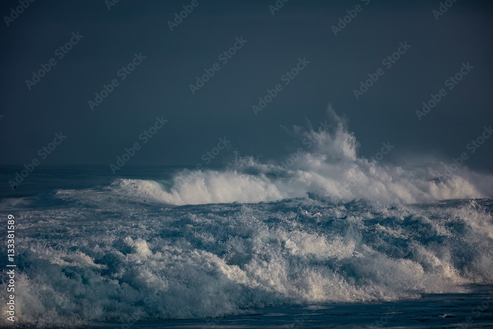 Wall mural huge waves crashing in ocean. seascape environment background. water texture with foam and splashes.