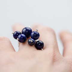 Silver rimgs with colorful precious stones and light grey background