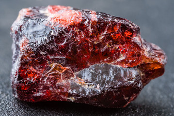 Uncut and rough deep red rhodolite garnet gemstone.