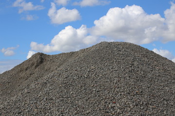 Heap of gravel in front of sky
