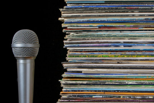 A stack of old records and microphone