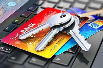 Credit cards and house keys on laptop keyboard
