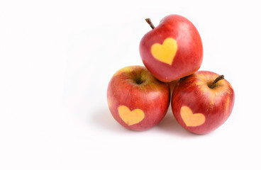  Red apples with shape of heart on a white background , cardiology, holiday  and health concept