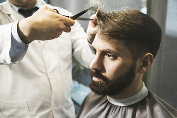 Close up of a man having his hair cut