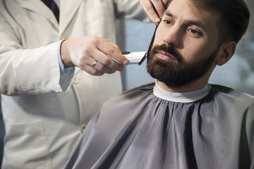 Close up of a man having his hair cut