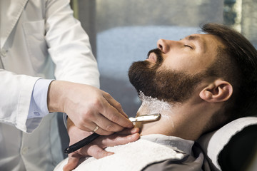 Close up of a man having his hair cut