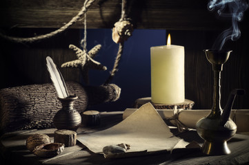 Vintage concept of sea travel, writing a letter on a wooden keg with a burning candle, smoking a hookah. Message in a bottle on old paper. Cabin wooden vessel, close-up, a pirate ship. Sea adventure.