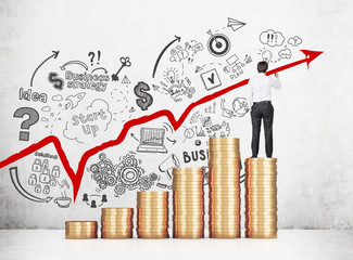 Man on stack of coins drawing a graph
