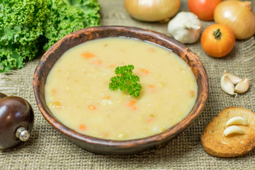 Fresh Vegetarian or vegan yellow split pea soup with parsley, on