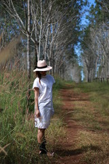 women were hat and white dress in the forest