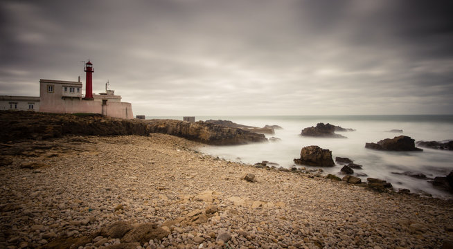 Lighthouse at cape Raso in Cascais, Portugal in a storm day