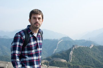 Naklejka premium Tired man at the Great wall of China