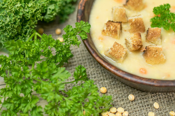 Fresh Vegetarian or vegan yellow split pea soup with parsley, on