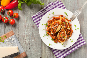 Italian pasta Conchiglioni Rigati stuffed with dry tomatoes and