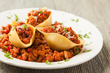 Italian pasta Conchiglioni Rigati stuffed with dry tomatoes and
