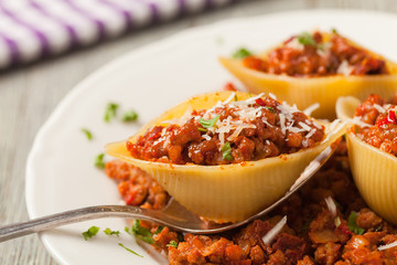 Italian pasta Conchiglioni Rigati stuffed with dry tomatoes and