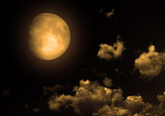 The moon in the night sky in clouds