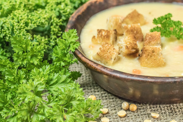 Fresh Vegetarian or vegan yellow split pea soup with parsley, on