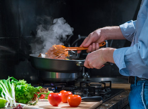 Man mixing food in a pan