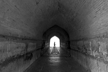 Perspective View Through a Dark Tunnel With Human Silhouette