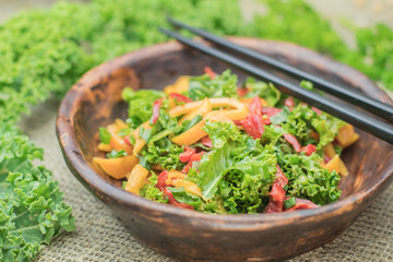 Fresh healthy raw nutritional salad with organic curly kale gree