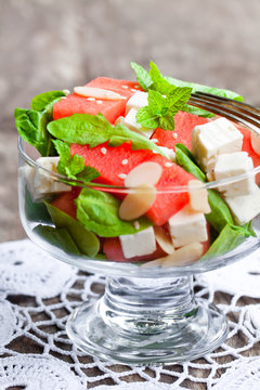 Salad  with fresh watermelon and feta with basil and spinach lea