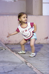 Fototapeta premium Little Girl shows finger as sign evidence she found something