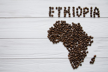 Map of the Ethiopia made of roasted coffee beans laying on white wooden textured background and...