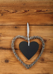 Heart shaped frame with blackboard on wooden wall