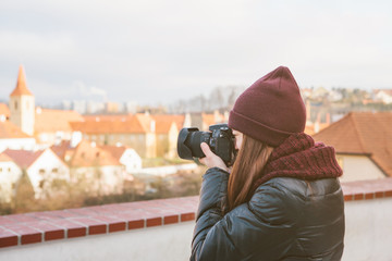 beautiful young female tourist photographing views of the European city