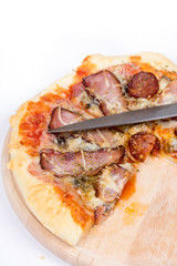 Flat lay overview of pizza with domestic ham sirloin and sausage