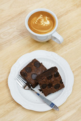 Chocolate brownie coffee latte break on wooden table