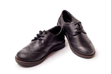 Black worn leather shoes on white background